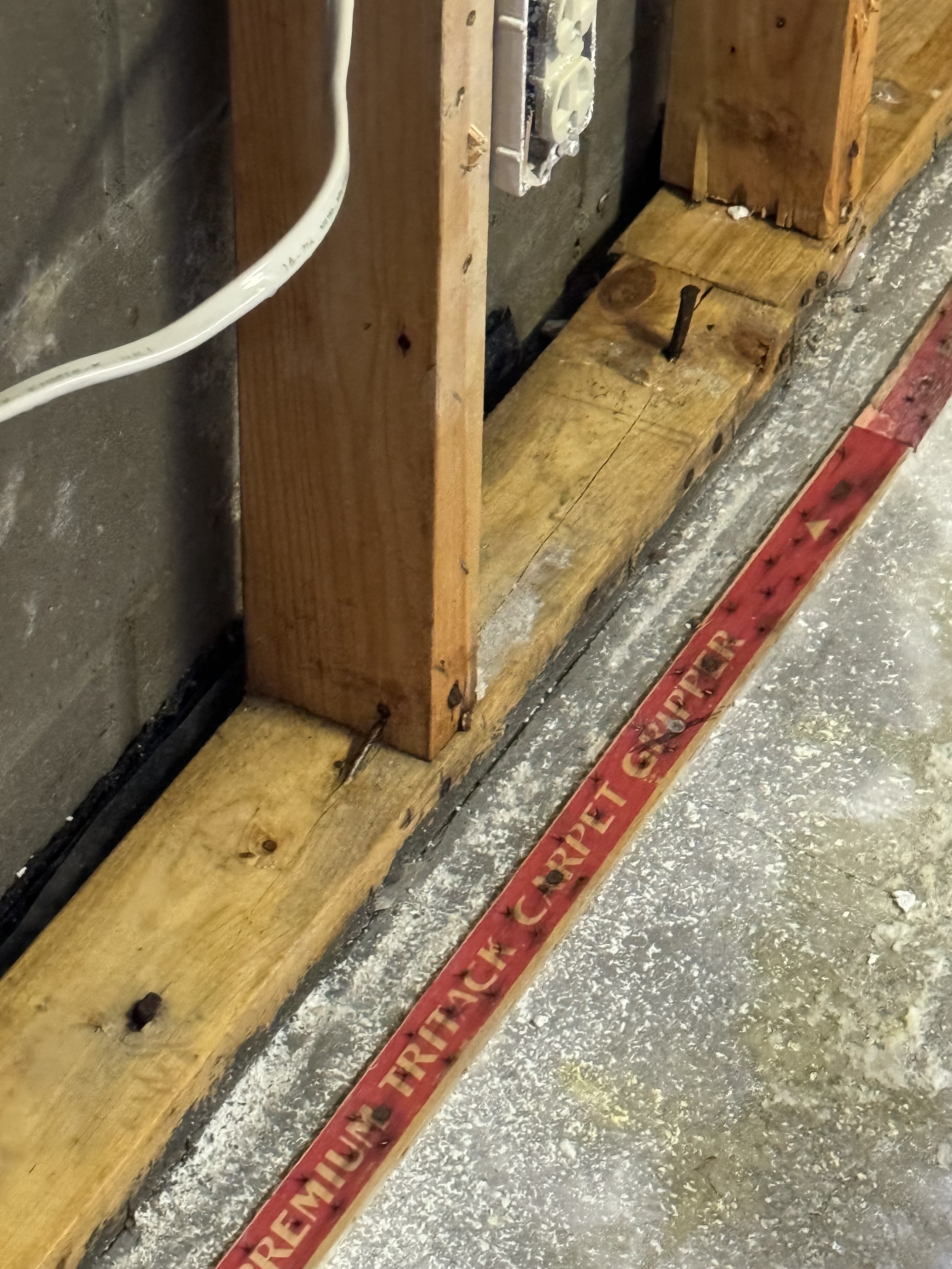 Professional flood cut along wall base showing proper water damage remediation technique